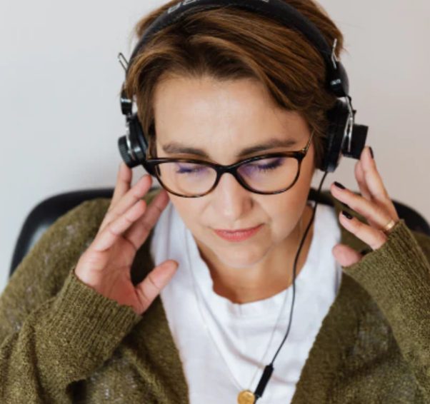 Woman experiencing tinnitus while listening with headphones
